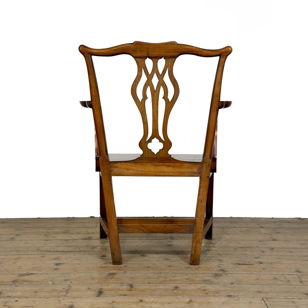An antique fruitwood armchair in the Chippendale style featuring a pierced back splat, shaped armrests, a solid wood seat, and square legs with stretchers. View VI