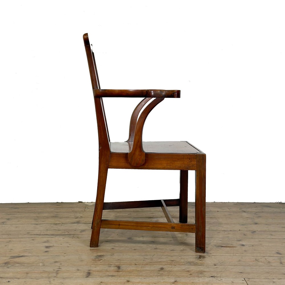 An antique fruitwood armchair in the Chippendale style featuring a pierced back splat, shaped armrests, a solid wood seat, and square legs with stretchers. View VII