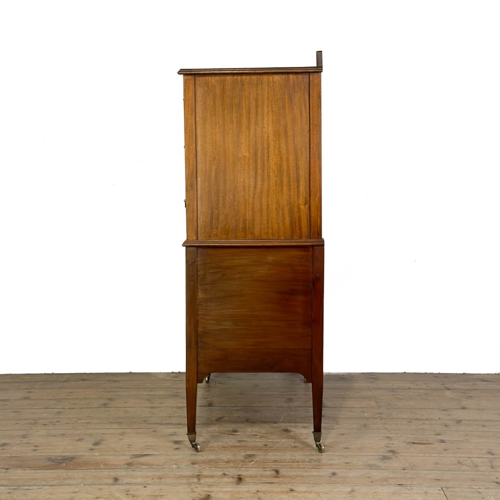 An antique Edwardian mahogany tallboy chest featuring three upper drawers above a double-door cupboard with satinwood string inlay and brass castors. View VI
