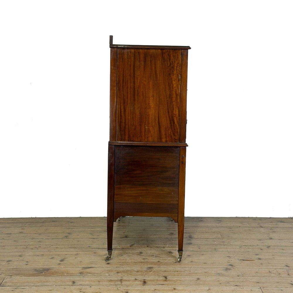 An antique Edwardian mahogany tallboy chest featuring three upper drawers above a double-door cupboard with satinwood string inlay and brass castors. View VIII