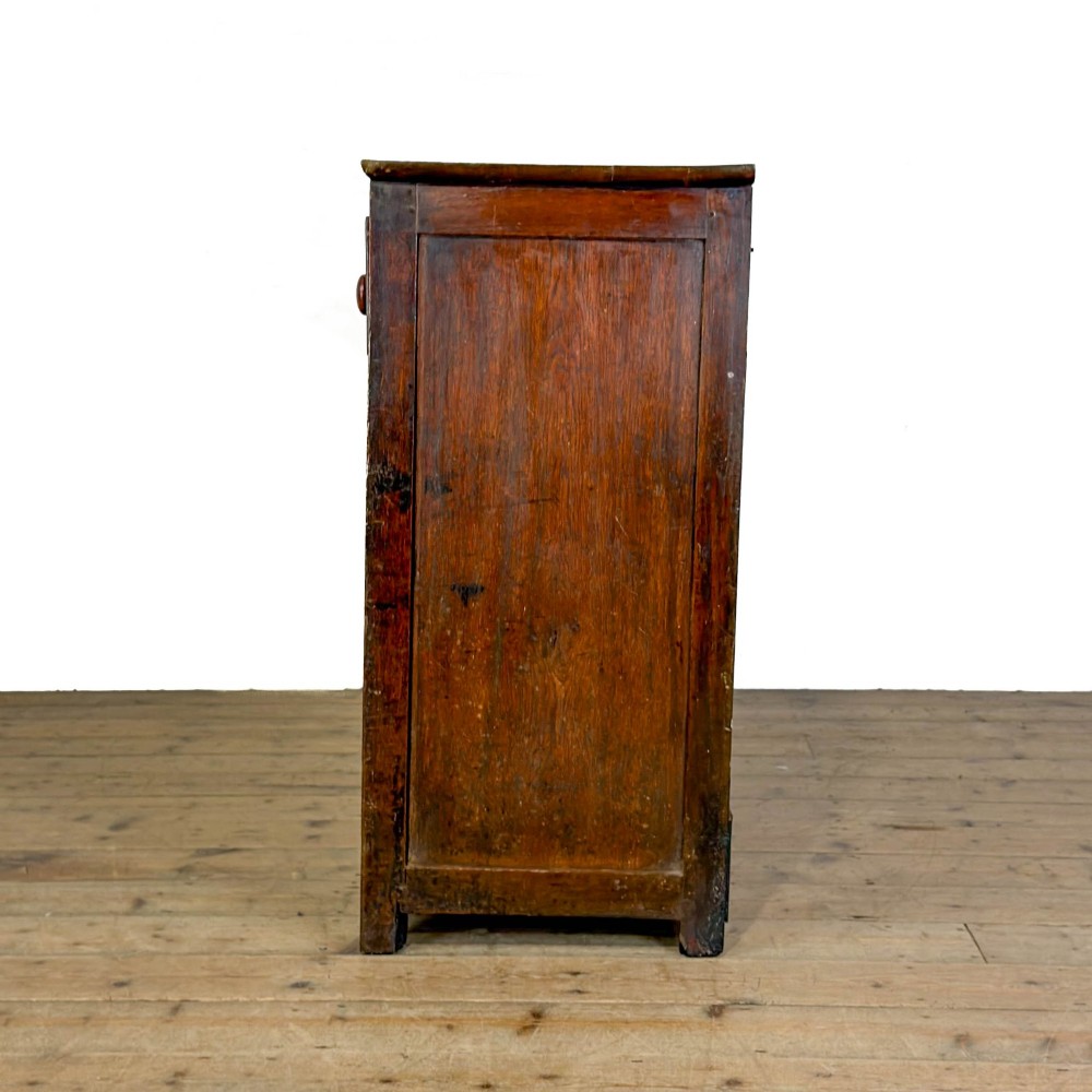A dark oak antique dresser base featuring three top drawers with wooden knobs and brass keyholes above two panelled cupboards flanking a central open alcove. View VIII