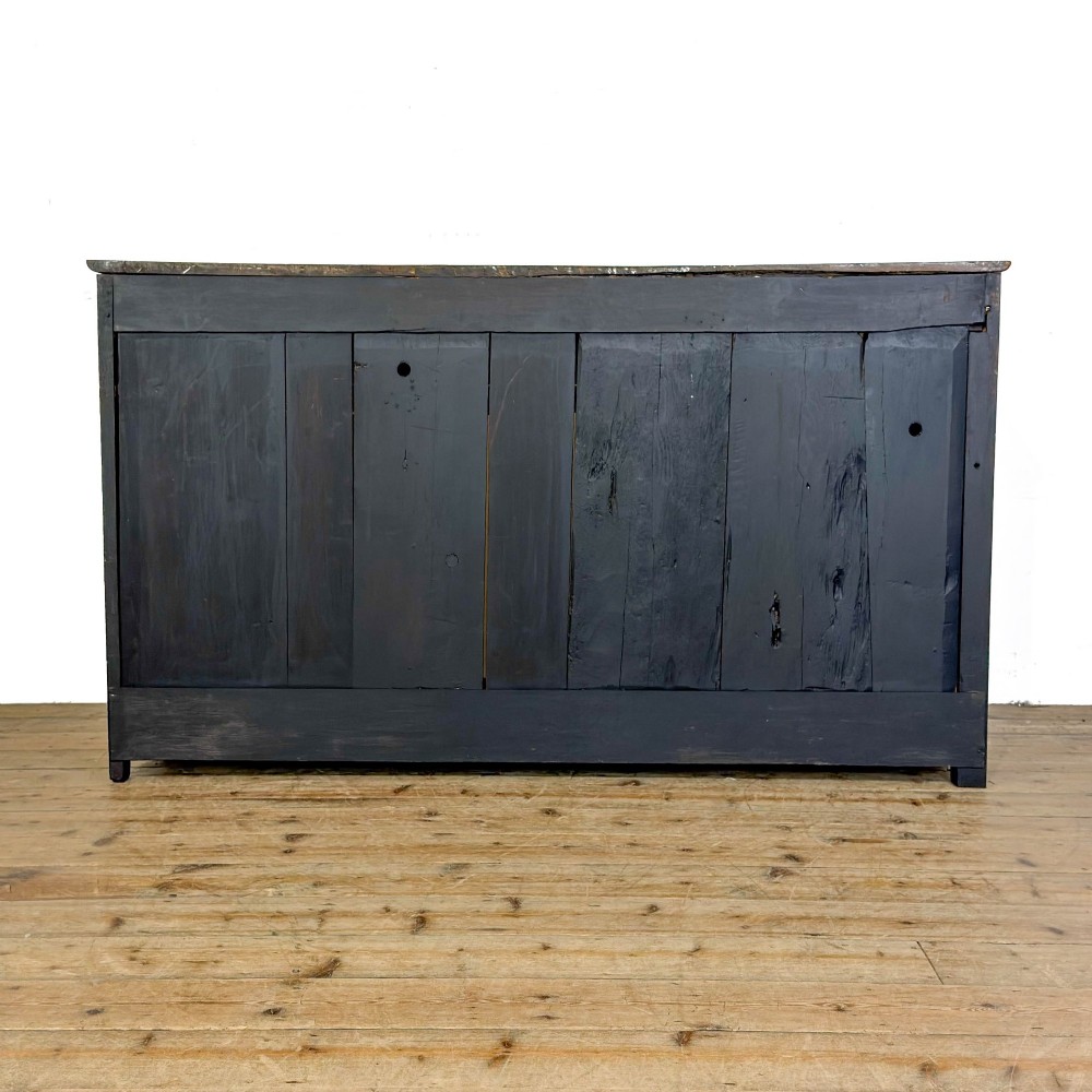 A dark oak antique dresser base featuring three top drawers with wooden knobs and brass keyholes above two panelled cupboards flanking a central open alcove. View IX