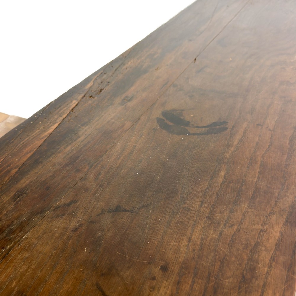 A dark oak antique dresser base featuring three top drawers with wooden knobs and brass keyholes above two panelled cupboards flanking a central open alcove. View XII