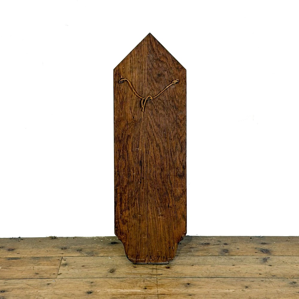 An antique solid oak hymn board featuring a pointed arched top with the word HYMNS cut out above five horizontal display slots. View IV