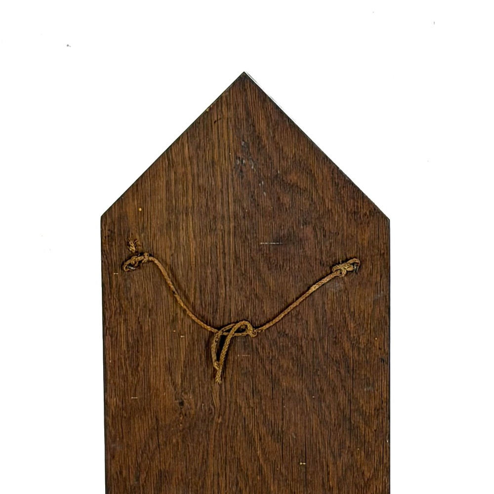 An antique solid oak hymn board featuring a pointed arched top with the word HYMNS cut out above five horizontal display slots. View V