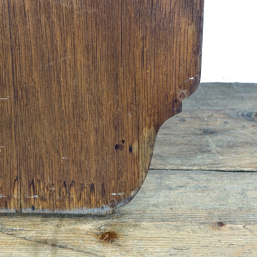 An antique solid oak hymn board featuring a pointed arched top with the word HYMNS cut out above five horizontal display slots. View VI