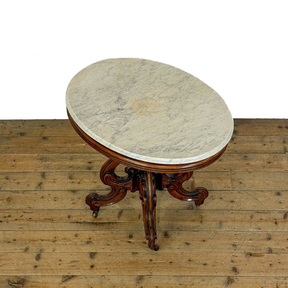A circular Victorian side table featuring a white marble top supported by a carved mahogany pedestal base with scrolled legs. View IV