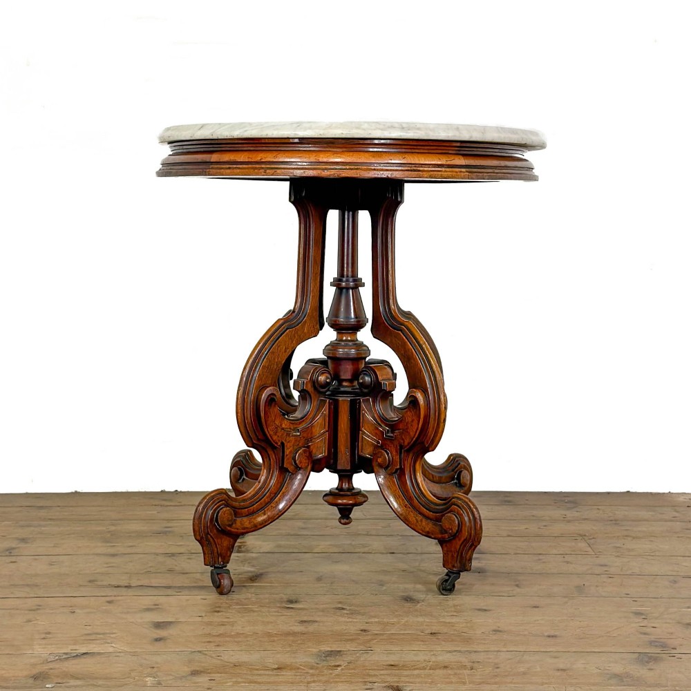A circular Victorian side table featuring a white marble top supported by a carved mahogany pedestal base with scrolled legs. View V