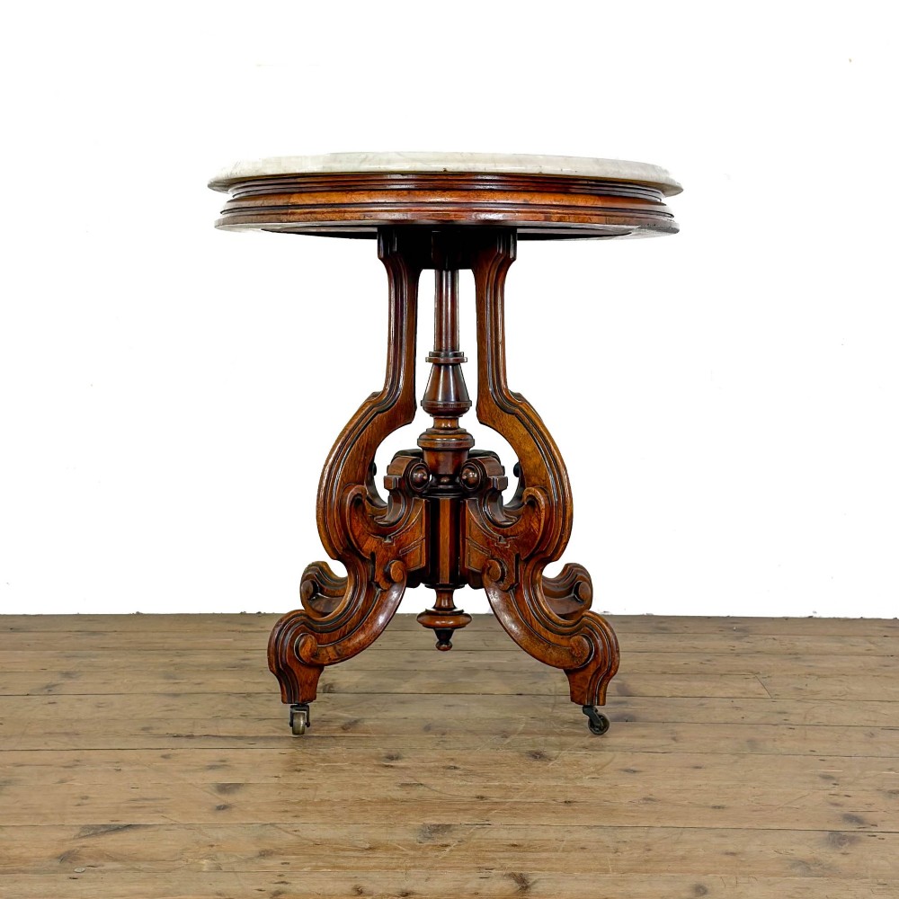 A circular Victorian side table featuring a white marble top supported by a carved mahogany pedestal base with scrolled legs. View VIII