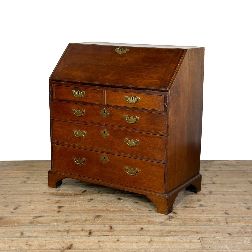 An 18th-century oak writing bureau featuring a sloping fall front above four graduated drawers with brass handles and bracket feet. View III