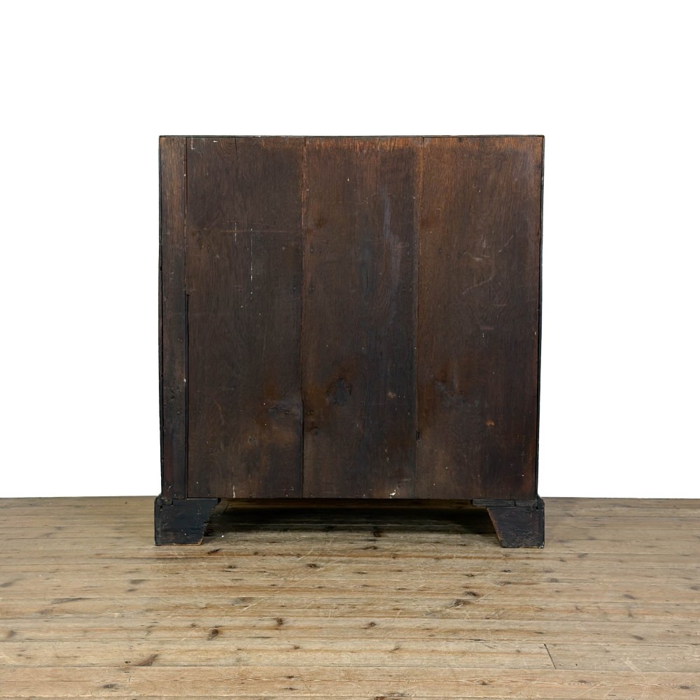 An 18th-century oak writing bureau featuring a sloping fall front above four graduated drawers with brass handles and bracket feet. View VIII
