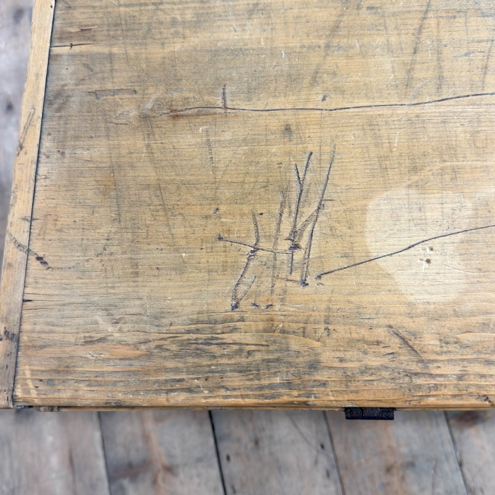 A rectangular stripped pine trunk displaying visible dovetail joints, a brass keyhole escutcheon, and a simple plinth base. View III