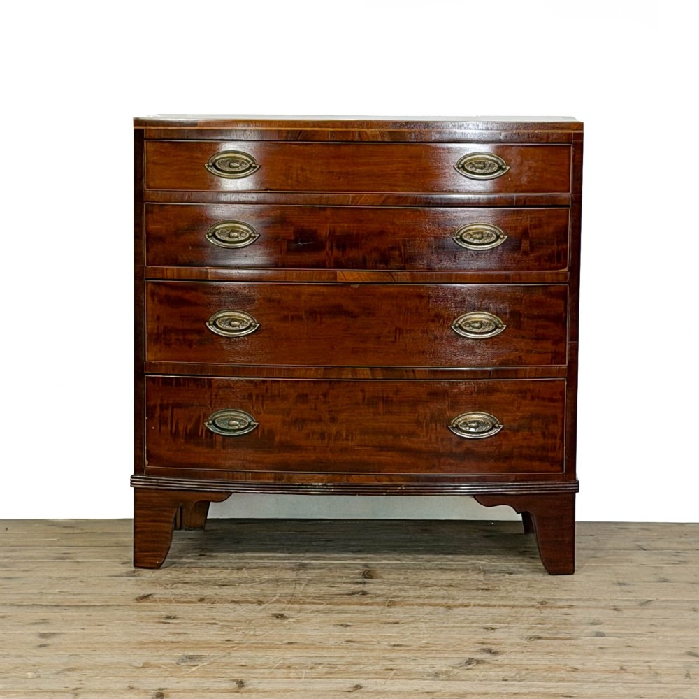An antique Georgian mahogany bow-front chest of drawers with four graduated drawers and brass oval drop handles.