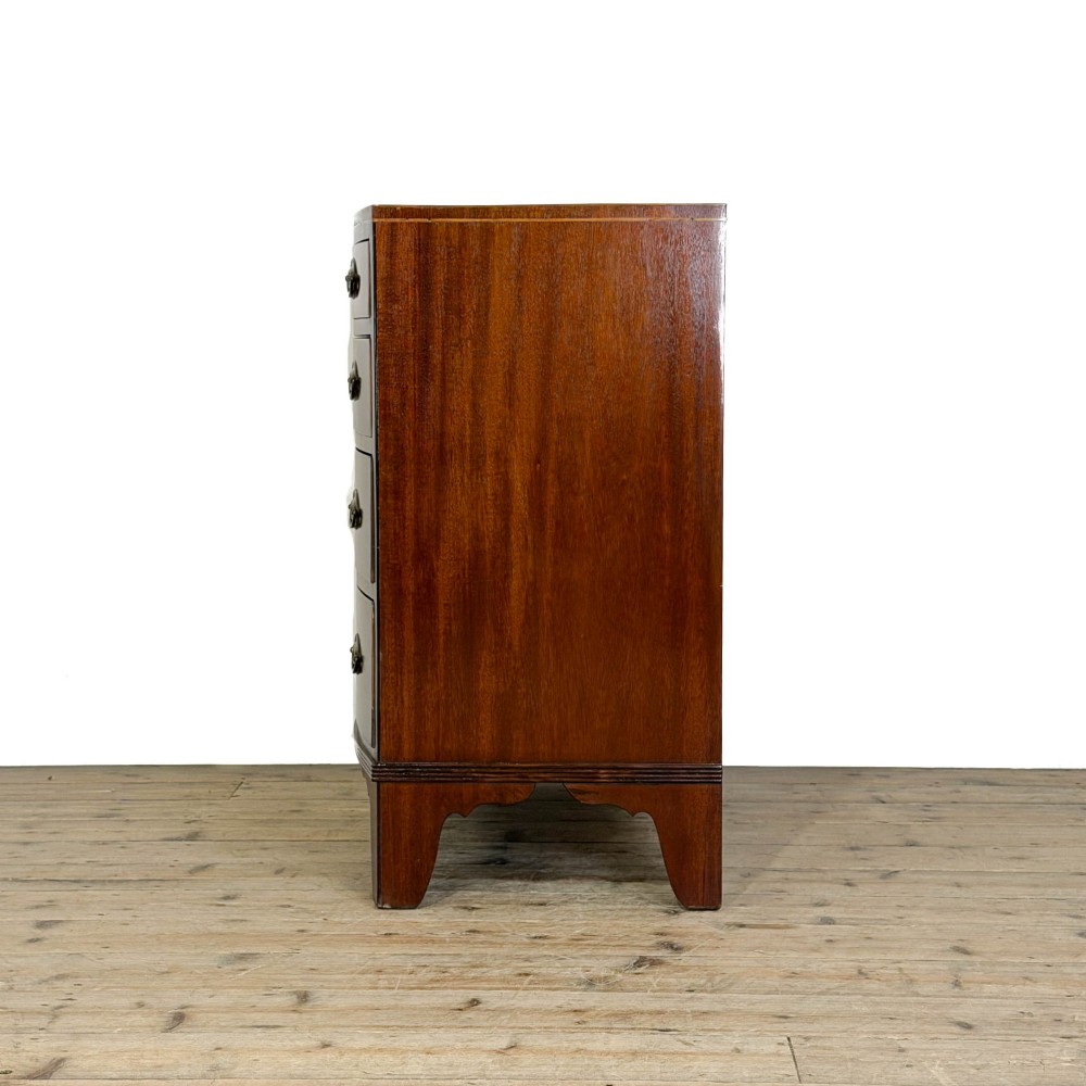An antique Georgian mahogany bow-front chest of drawers with four graduated drawers and brass oval drop handles. View IV