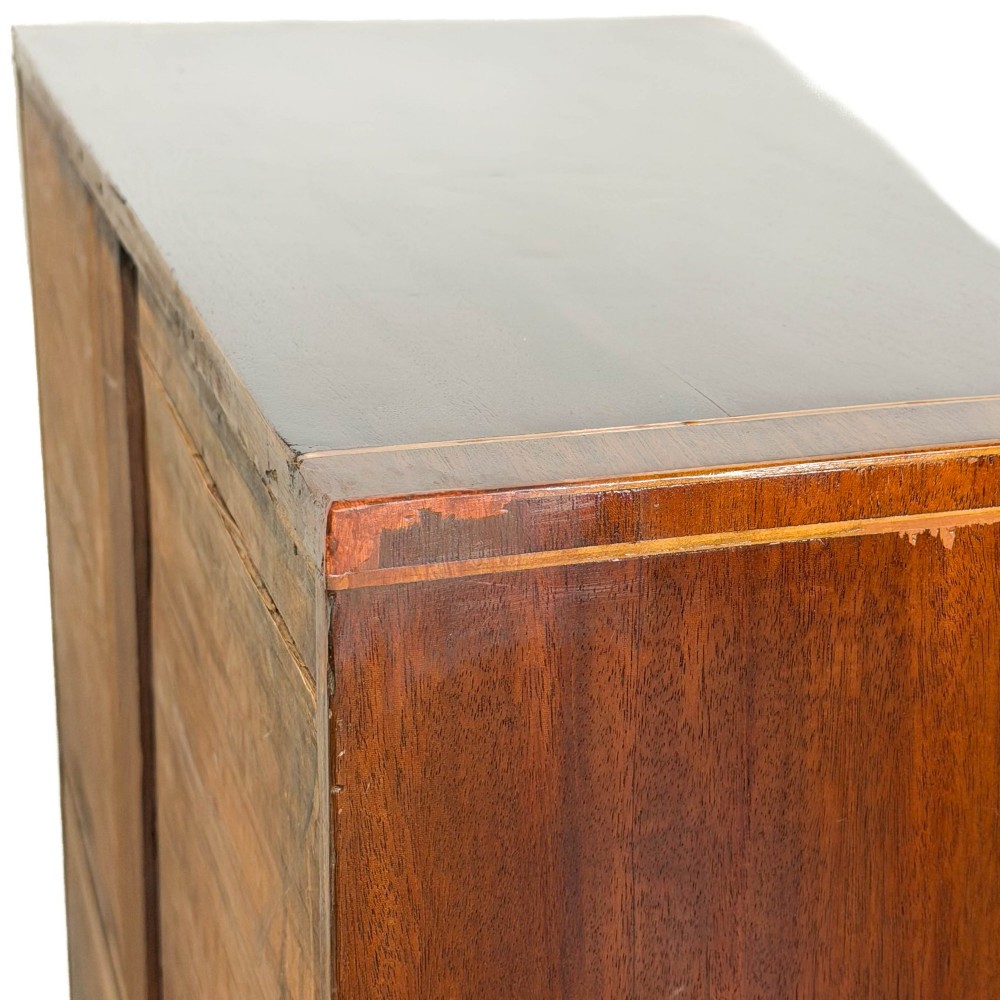 An antique Georgian mahogany bow-front chest of drawers with four graduated drawers and brass oval drop handles. View VIII
