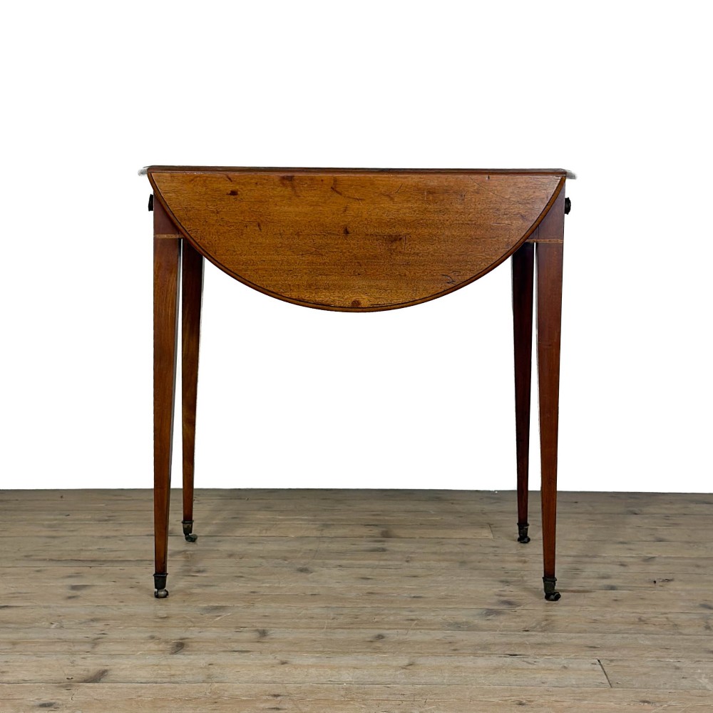 A 19th-century mahogany Pembroke table featuring two curved drop leaves, a single drawer with round brass knobs, and four square tapered legs on castors. View III
