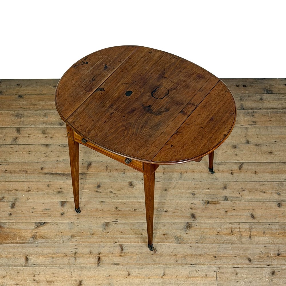 A 19th-century mahogany Pembroke table featuring two curved drop leaves, a single drawer with round brass knobs, and four square tapered legs on castors. View V