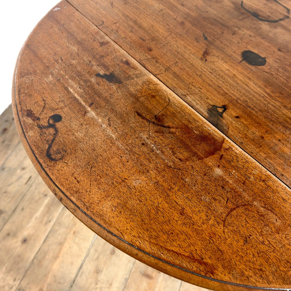 A 19th-century mahogany Pembroke table featuring two curved drop leaves, a single drawer with round brass knobs, and four square tapered legs on castors. View VII