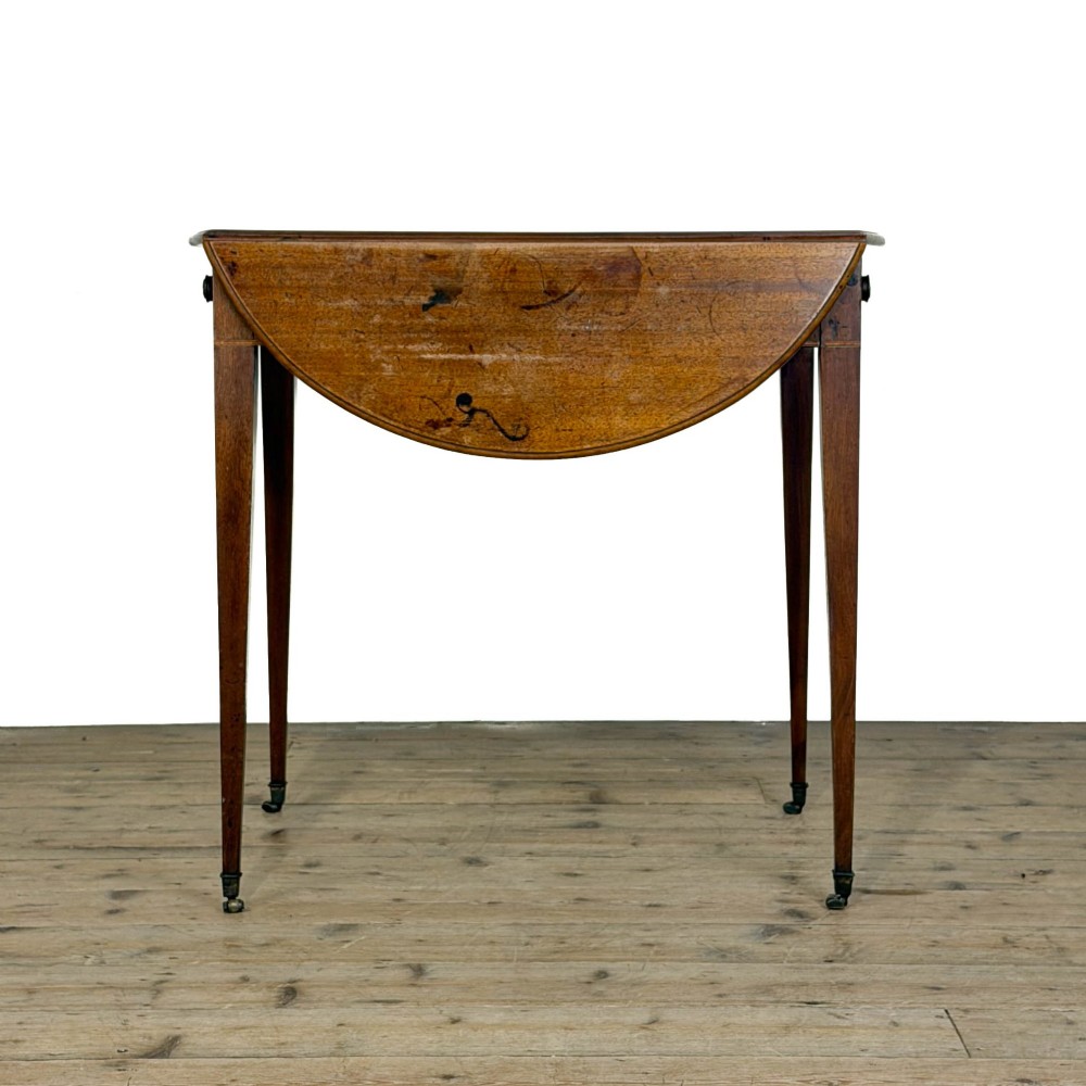A 19th-century mahogany Pembroke table featuring two curved drop leaves, a single drawer with round brass knobs, and four square tapered legs on castors. View VIII
