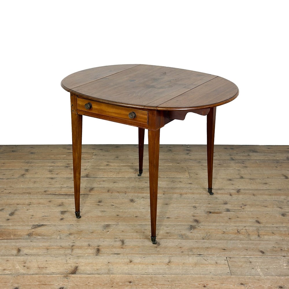 A 19th-century mahogany Pembroke table featuring two curved drop leaves, a single drawer with round brass knobs, and four square tapered legs on castors. View XI
