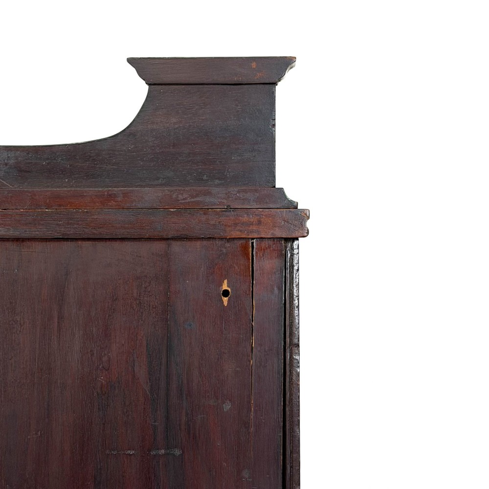 An antique dark wood Art Nouveau display cabinet featuring floral marquetry inlays, a single glazed glass door, and a shaped cresting gallery. View II