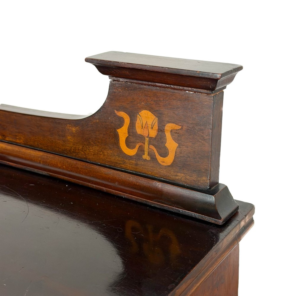 An antique dark wood Art Nouveau display cabinet featuring floral marquetry inlays, a single glazed glass door, and a shaped cresting gallery. View IV