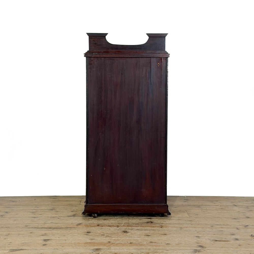 An antique dark wood Art Nouveau display cabinet featuring floral marquetry inlays, a single glazed glass door, and a shaped cresting gallery. View IX