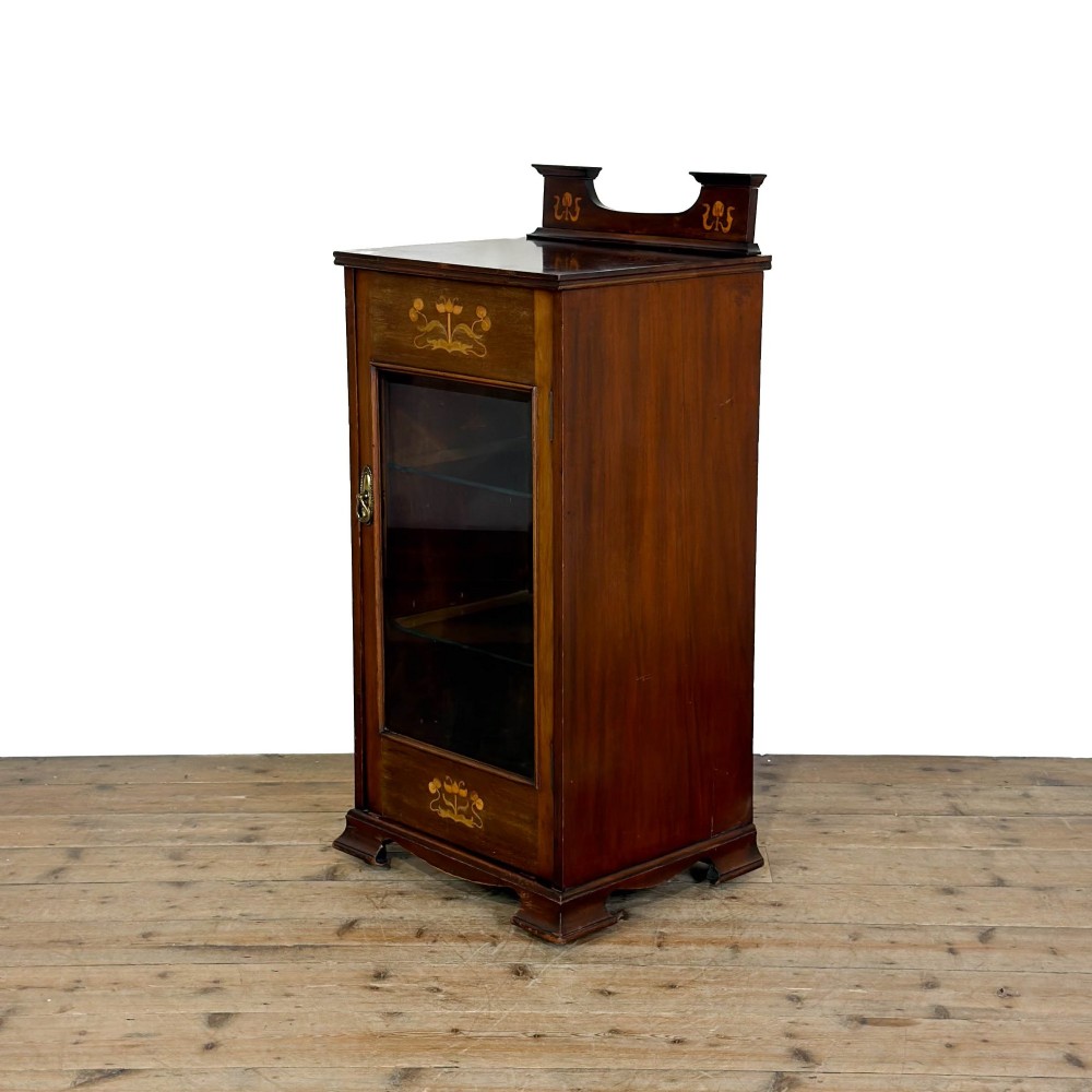 An antique dark wood Art Nouveau display cabinet featuring floral marquetry inlays, a single glazed glass door, and a shaped cresting gallery. View XII