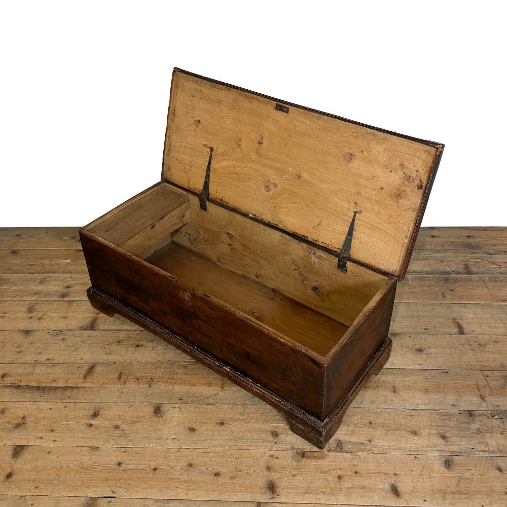 A rectangular George III dark elm blanket chest with a hinged lid, brass escutcheon, and bracket feet. View III