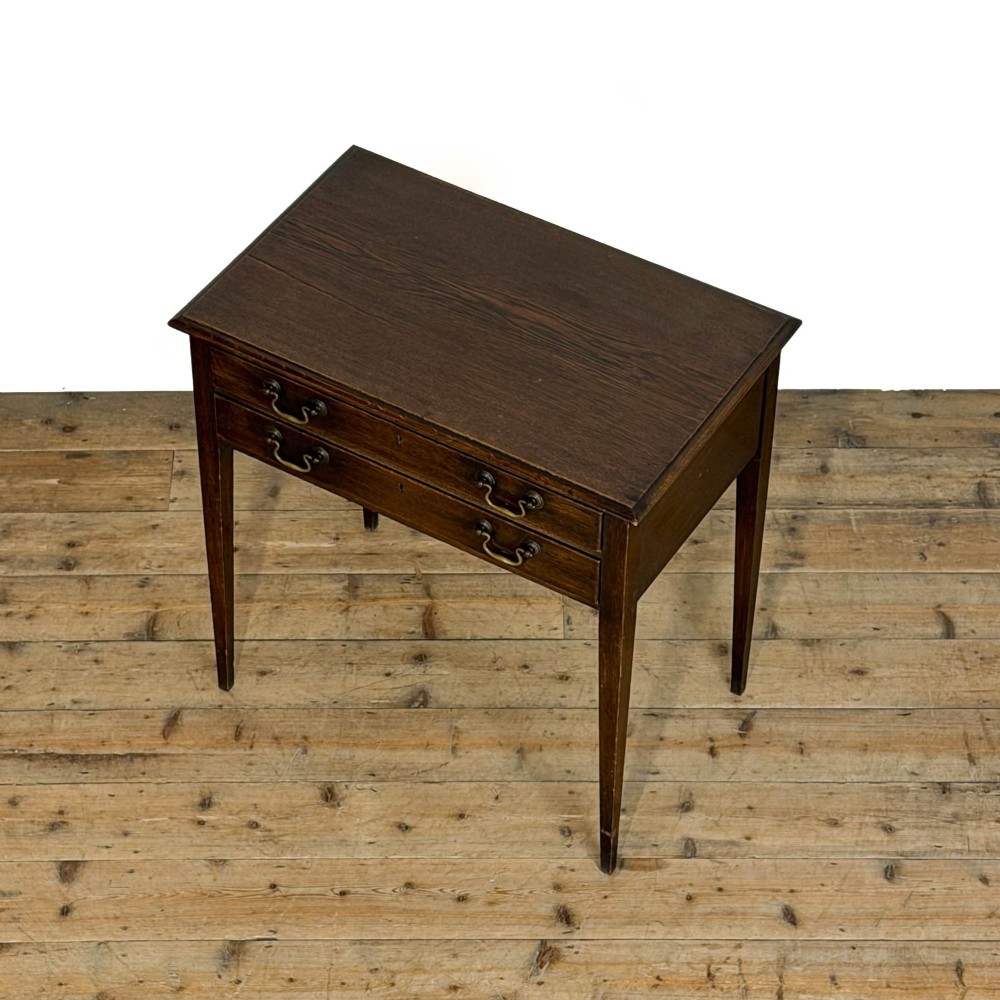 A dark oak lowboy table with two stacked drawers featuring brass drop handles and tapered square legs. View IV