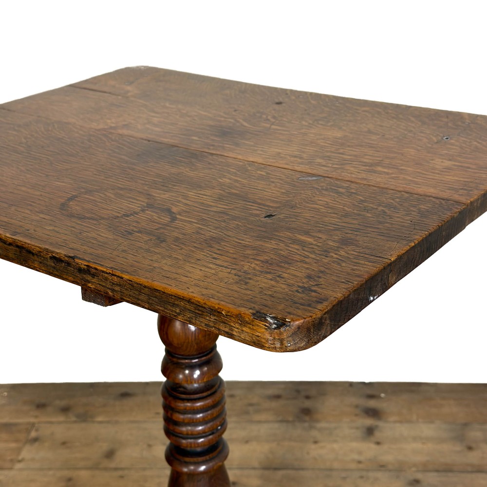 A 19th-century oak tilt-top table featuring a rectangular surface set upon a turned central column with three cabriole tripod legs. View II