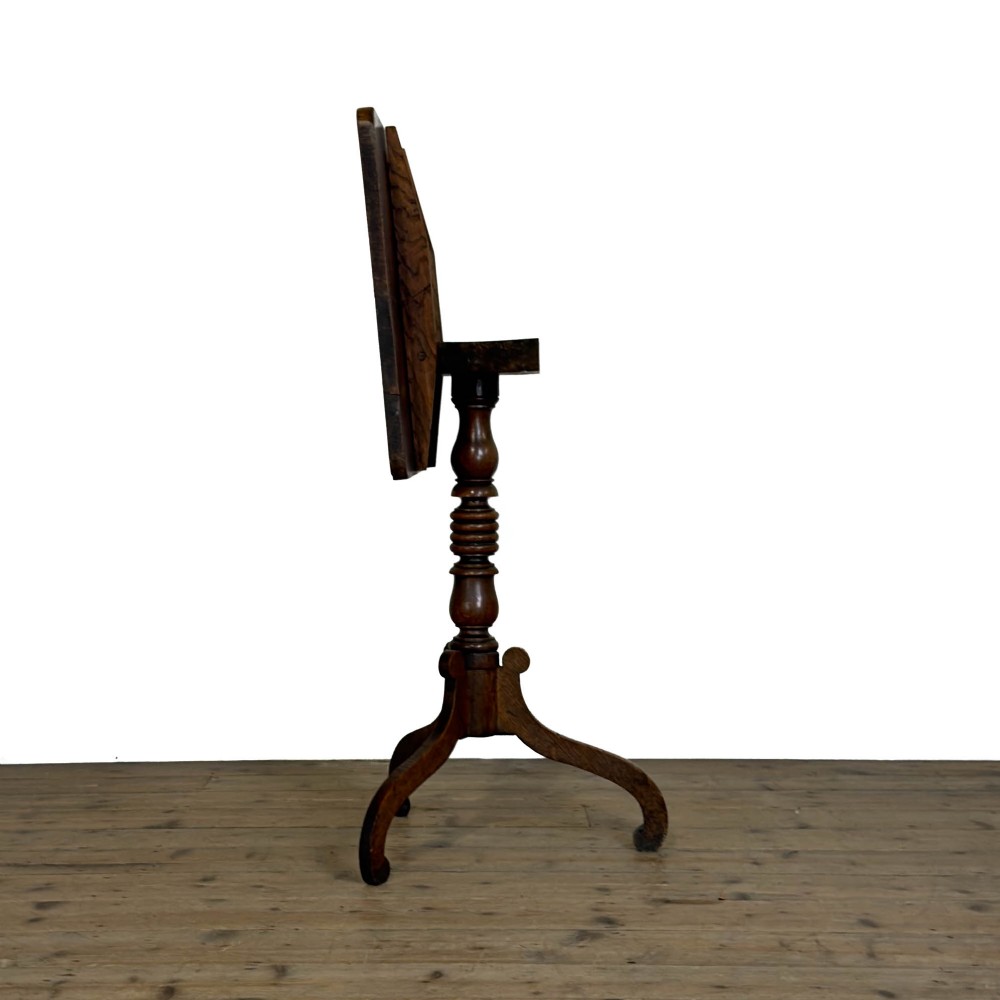 A 19th-century oak tilt-top table featuring a rectangular surface set upon a turned central column with three cabriole tripod legs. View IV