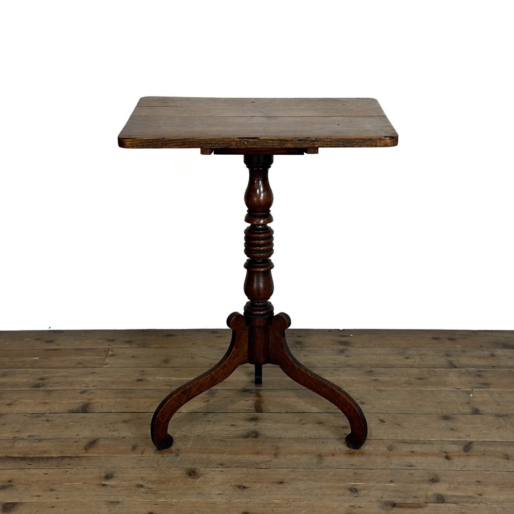 A 19th-century oak tilt-top table featuring a rectangular surface set upon a turned central column with three cabriole tripod legs. View VIII