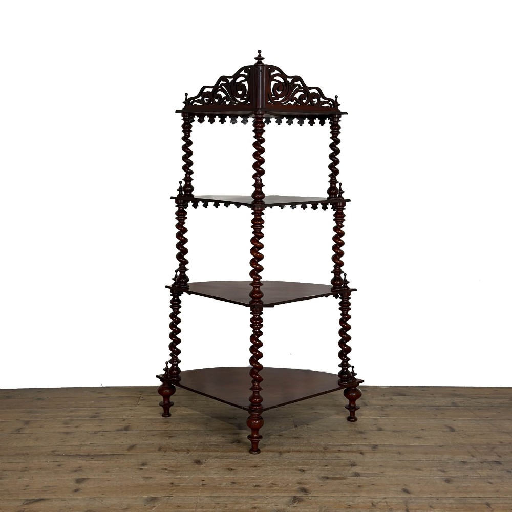 A four-tier Victorian mahogany corner whatnot featuring open shelving supported by barley twist columns and topped with a pierced fretwork pediment. View III