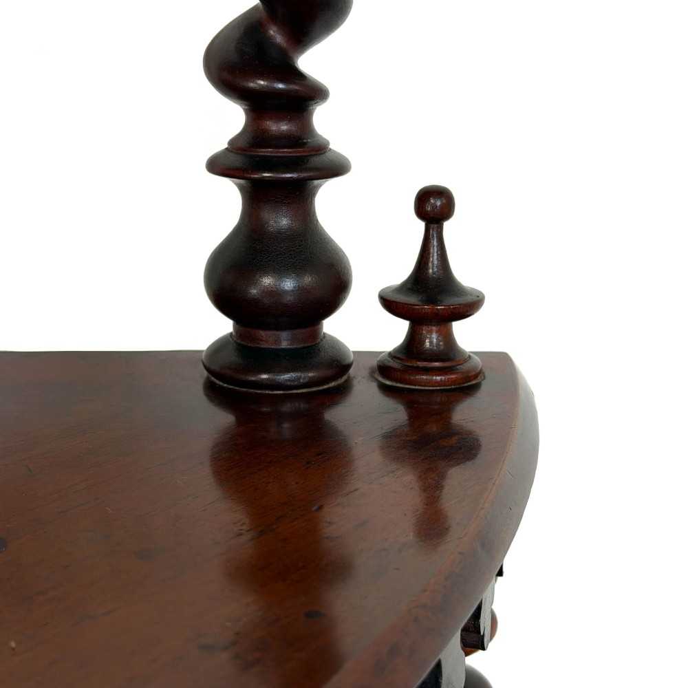 A four-tier Victorian mahogany corner whatnot featuring open shelving supported by barley twist columns and topped with a pierced fretwork pediment. View VI