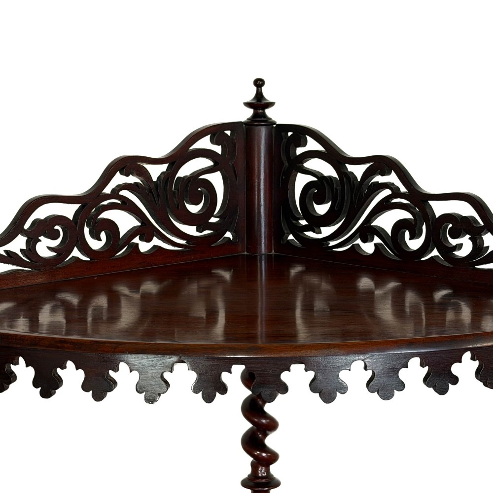 A four-tier Victorian mahogany corner whatnot featuring open shelving supported by barley twist columns and topped with a pierced fretwork pediment. View VII