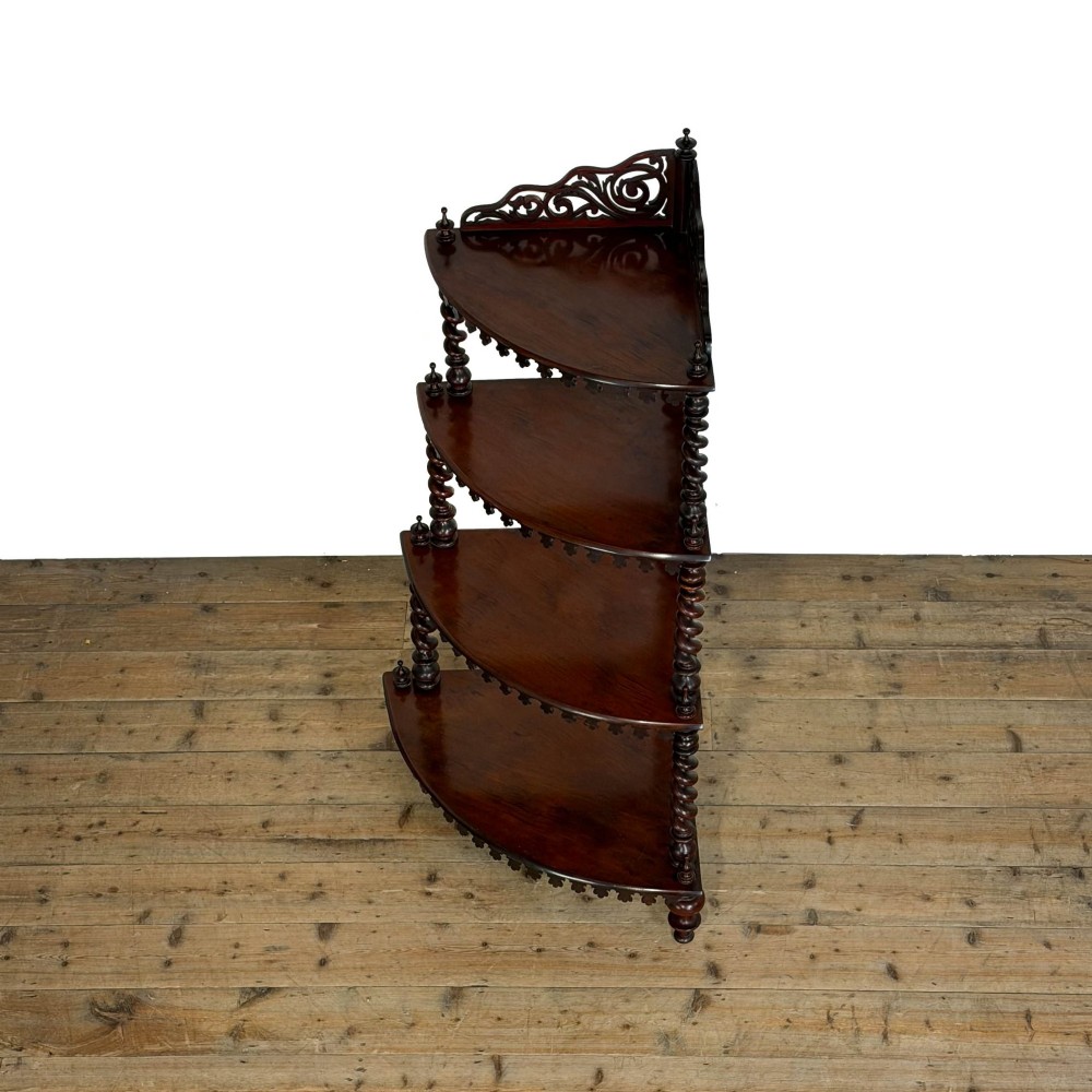A four-tier Victorian mahogany corner whatnot featuring open shelving supported by barley twist columns and topped with a pierced fretwork pediment. View IX