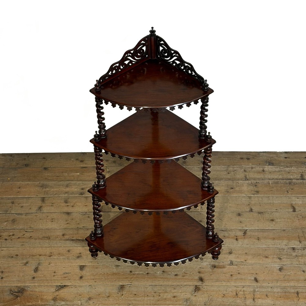 A four-tier Victorian mahogany corner whatnot featuring open shelving supported by barley twist columns and topped with a pierced fretwork pediment. View X