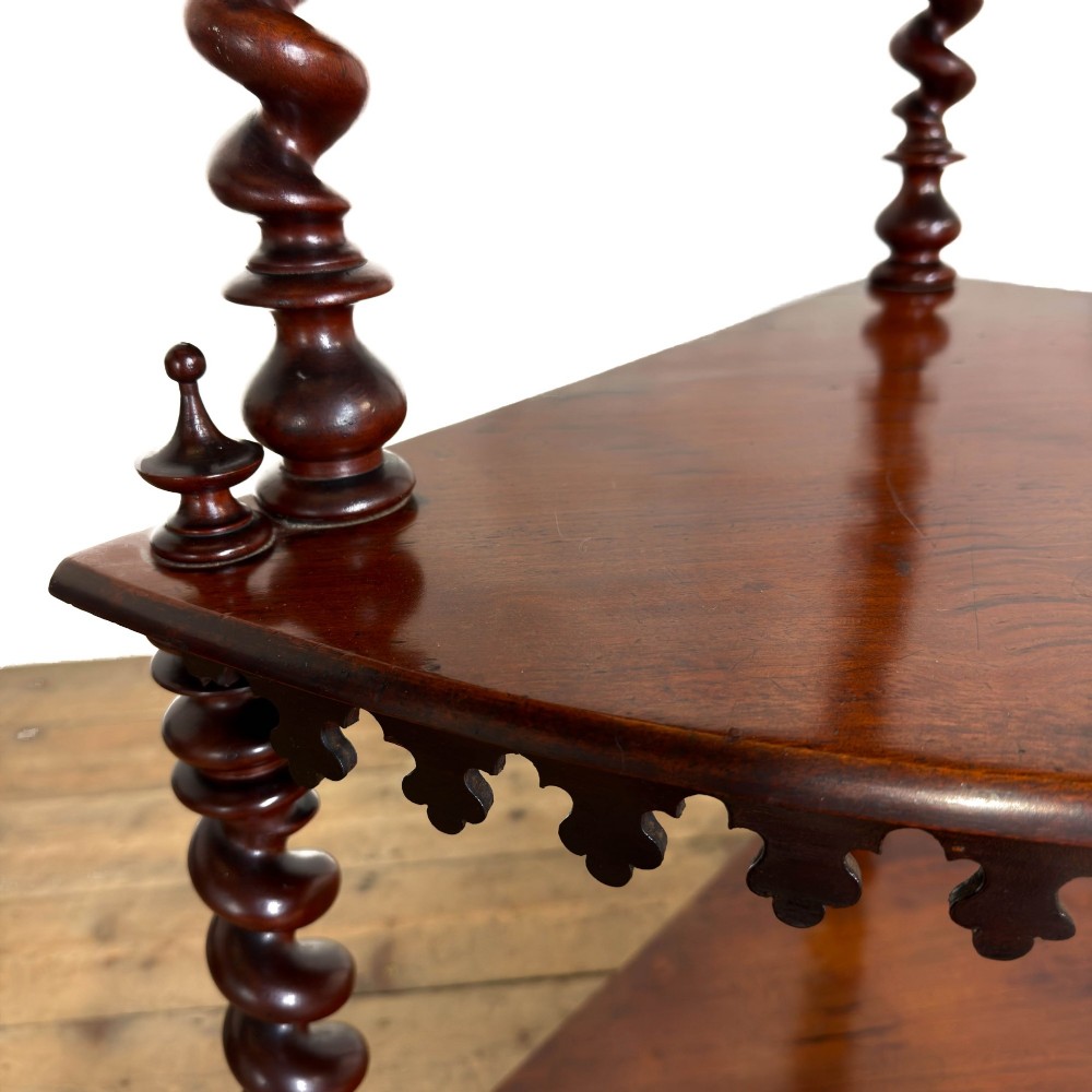 A four-tier Victorian mahogany corner whatnot featuring open shelving supported by barley twist columns and topped with a pierced fretwork pediment. View XI