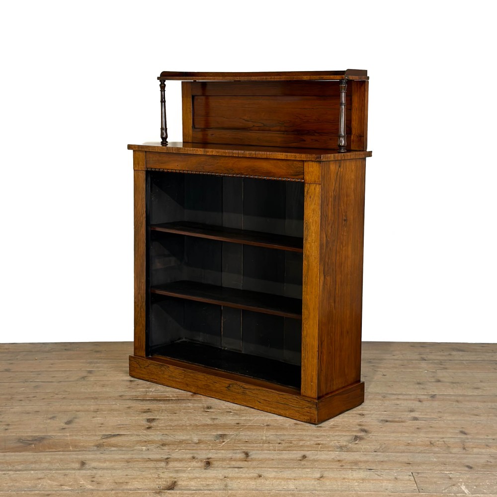 An antique rosewood open bookcase featuring a raised back gallery flanked by turned columns, with three open shelves and a beaded trim. View II