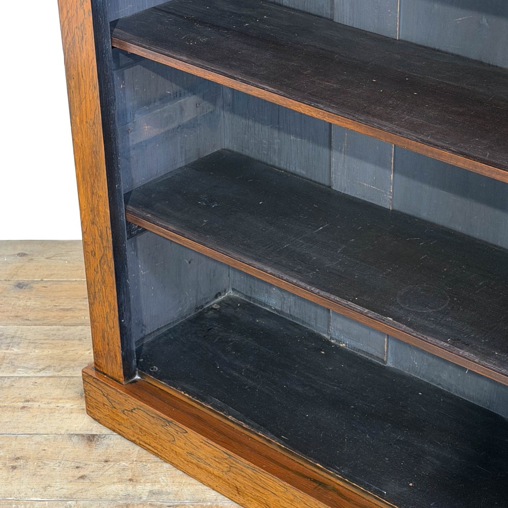 An antique rosewood open bookcase featuring a raised back gallery flanked by turned columns, with three open shelves and a beaded trim. View V