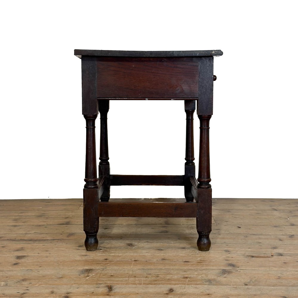 An 18th-century dark oak side table featuring a single drawer with turned wooden knobs, turned front legs, and lower stretchers. View III