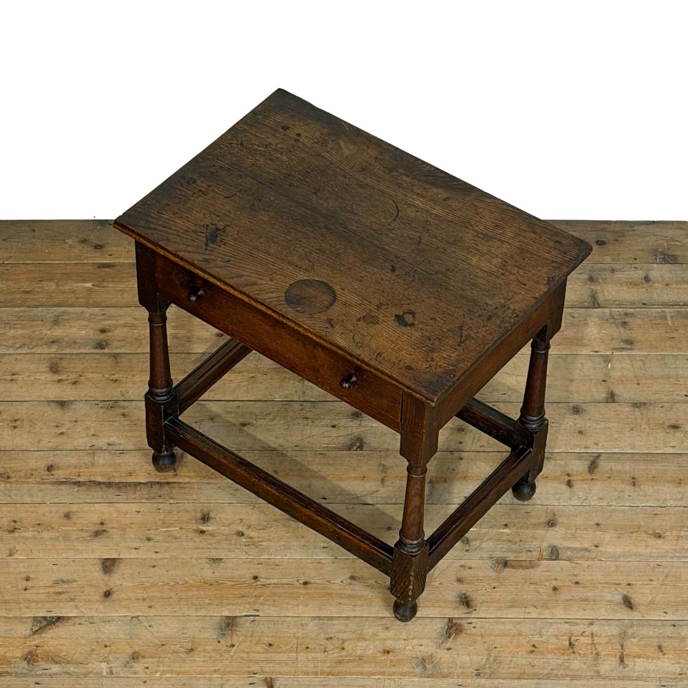 An 18th-century dark oak side table featuring a single drawer with turned wooden knobs, turned front legs, and lower stretchers. View IV