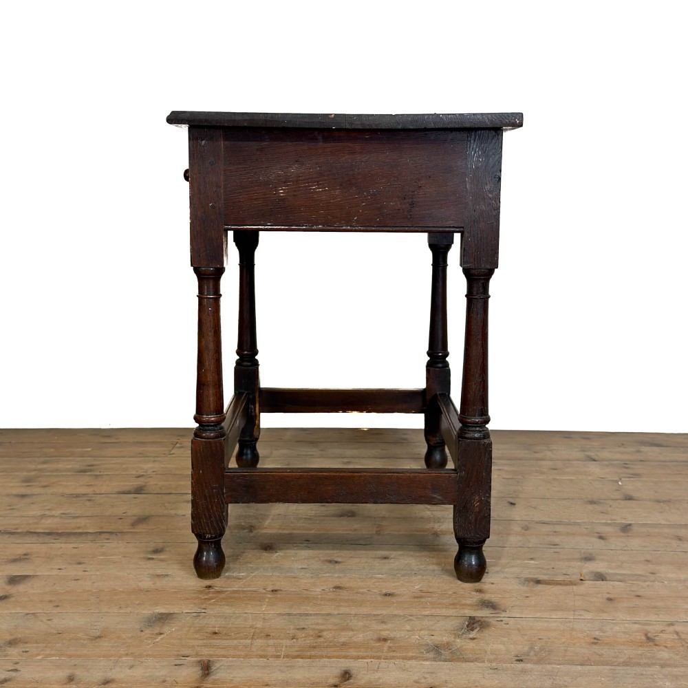 An 18th-century dark oak side table featuring a single drawer with turned wooden knobs, turned front legs, and lower stretchers. View VII