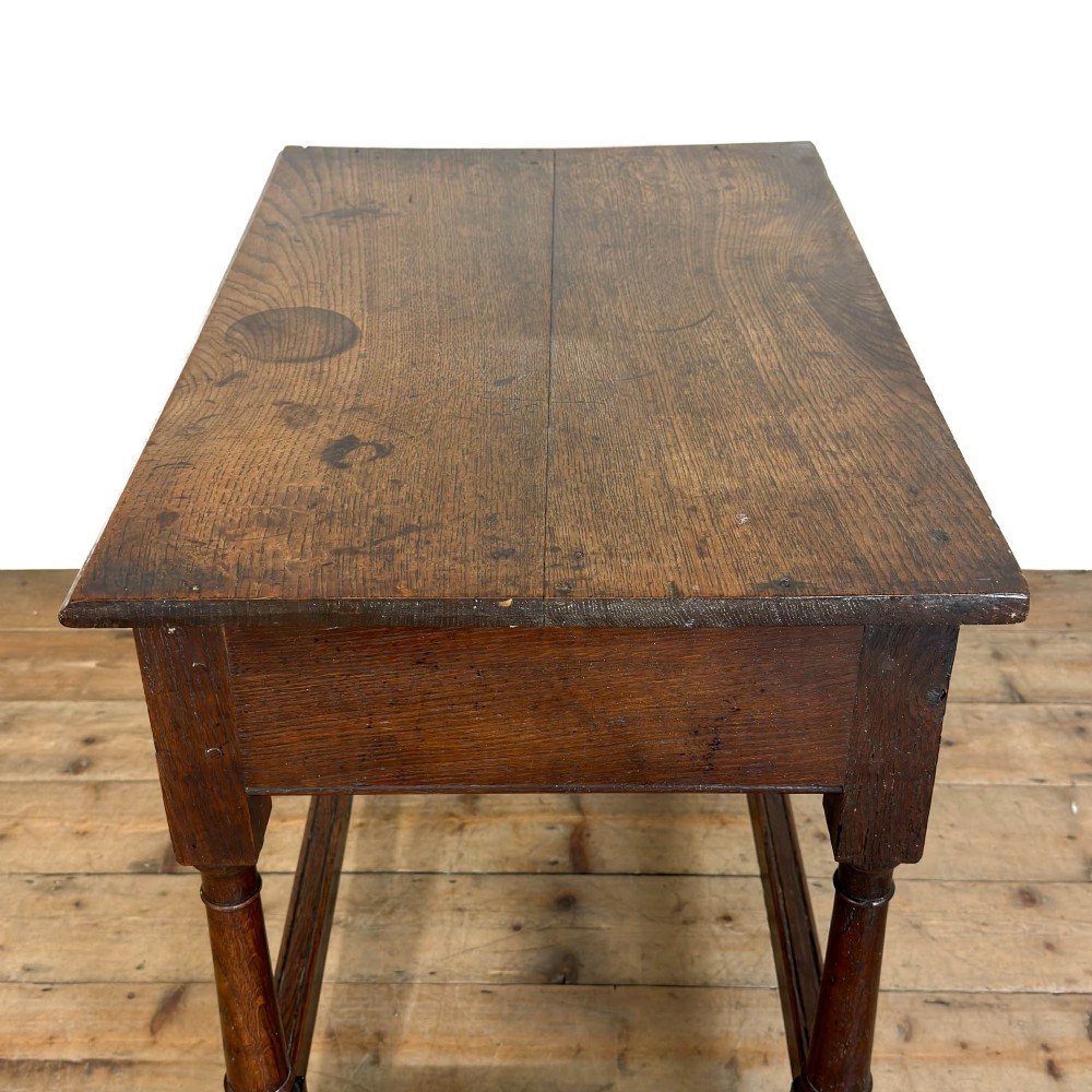 An 18th-century dark oak side table featuring a single drawer with turned wooden knobs, turned front legs, and lower stretchers. View VIII