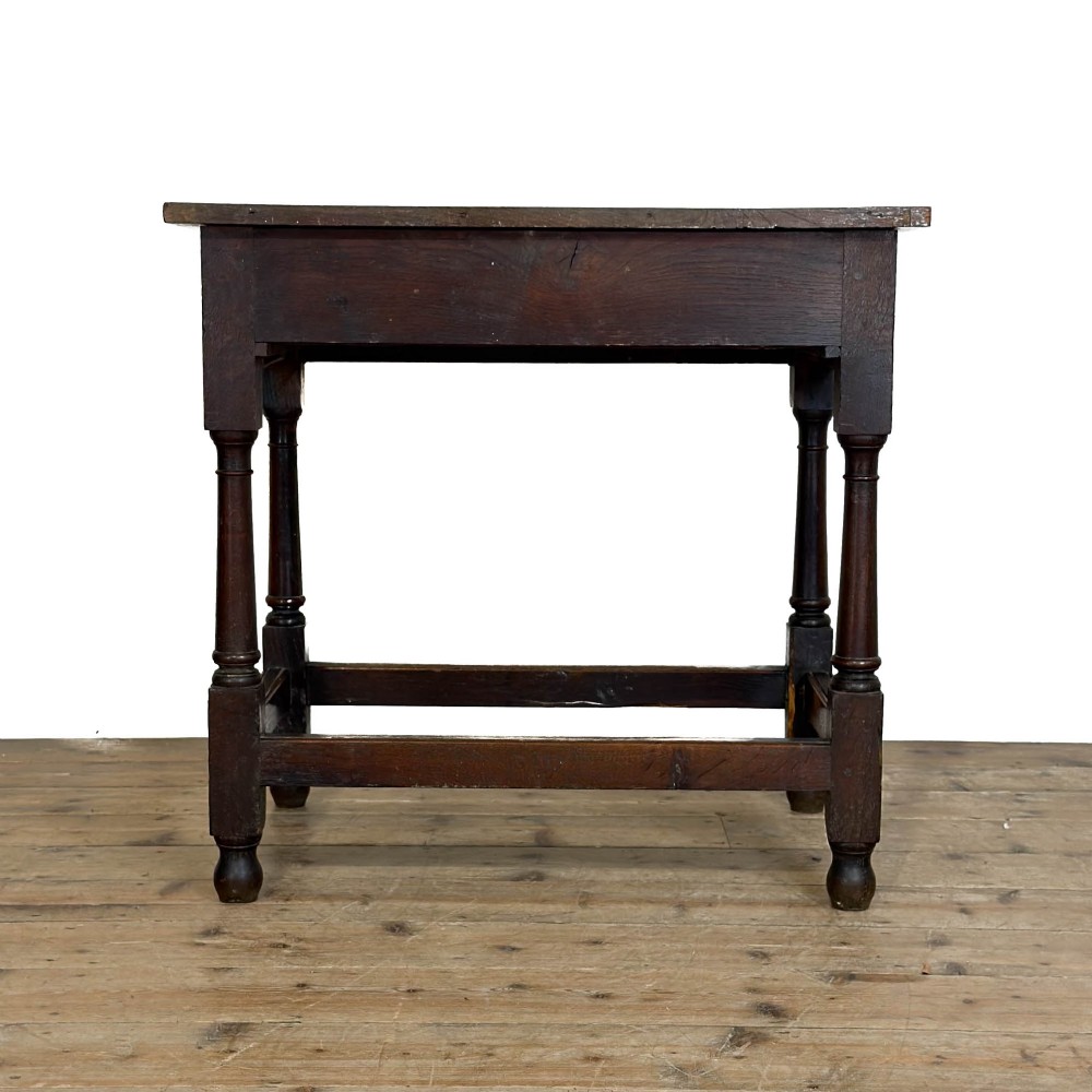 An 18th-century dark oak side table featuring a single drawer with turned wooden knobs, turned front legs, and lower stretchers. View IX