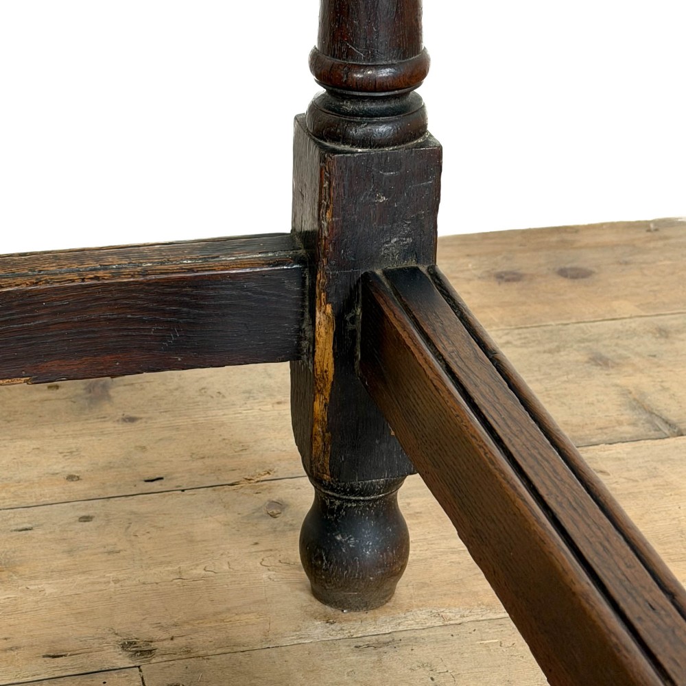 An 18th-century dark oak side table featuring a single drawer with turned wooden knobs, turned front legs, and lower stretchers. View X