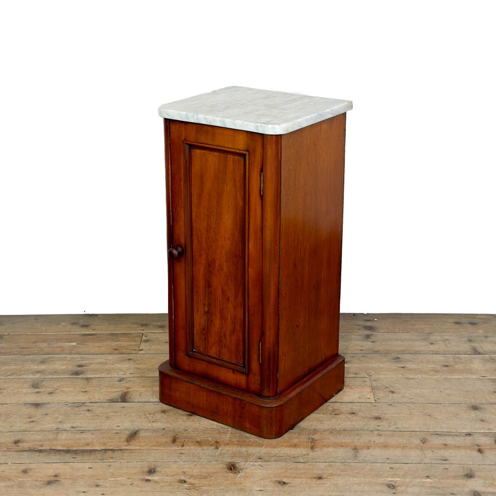 A Victorian mahogany pot cupboard featuring a single panelled door with a turned handle and a white marble top. View II