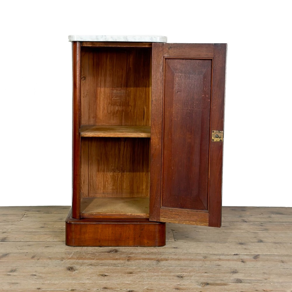 A Victorian mahogany pot cupboard featuring a single panelled door with a turned handle and a white marble top. View IV