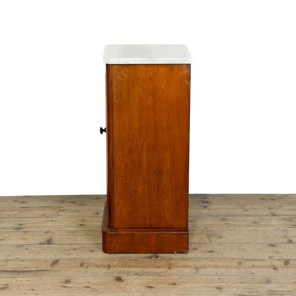 A Victorian mahogany pot cupboard featuring a single panelled door with a turned handle and a white marble top. View VI